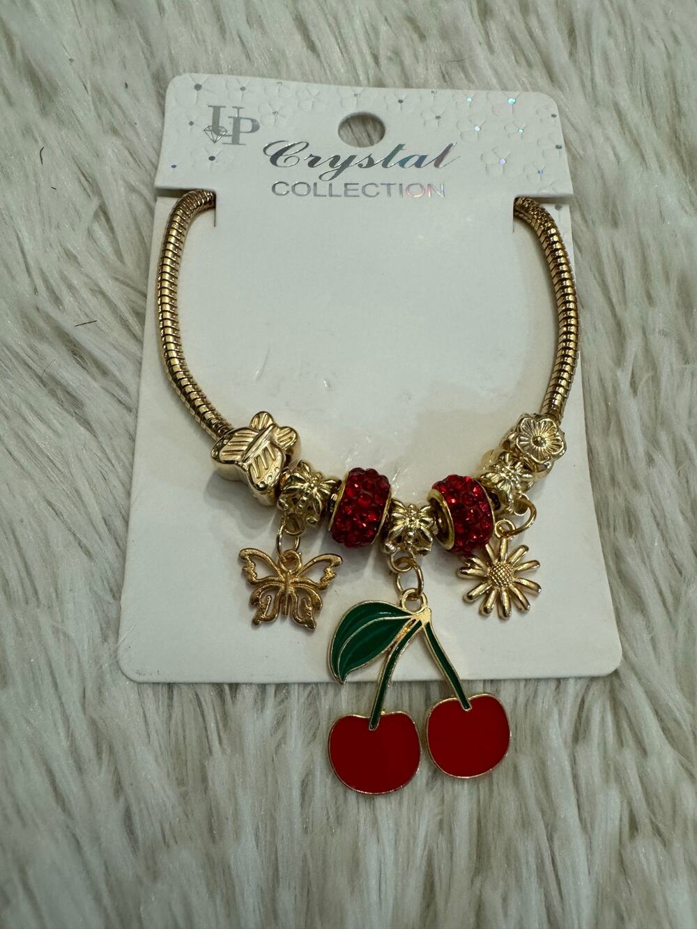 Gold & red cherry bracelet with butterfly and flower charms adjustable